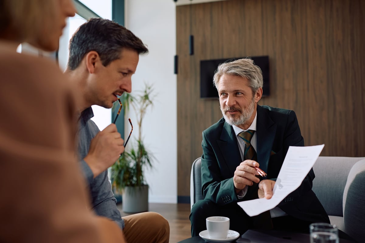 Insurance agent reviewing auto policy options with a couple